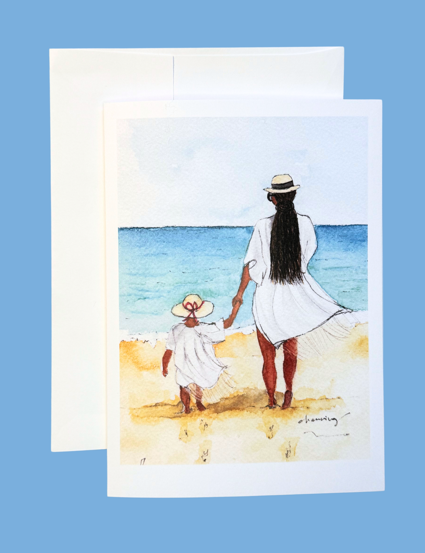 back of a woman with long black braids and a child walking on a beach together.